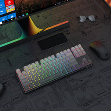 Gaming keyboard with RGB lighting on a desk with a computer monitor and mouse.