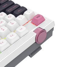 Close-up of a mechanical keyboard with pink escape key on a white background