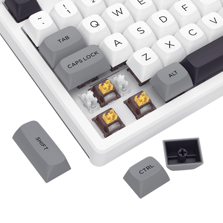 Close-up of a mechanical keyboard with white keycaps and gold accents on a black background.