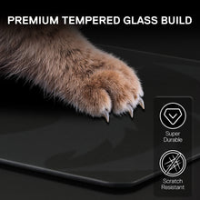 Cat paw on a black surface with text 'Premium Tempered Glass Build' and icons indicating durability and scratch resistance.